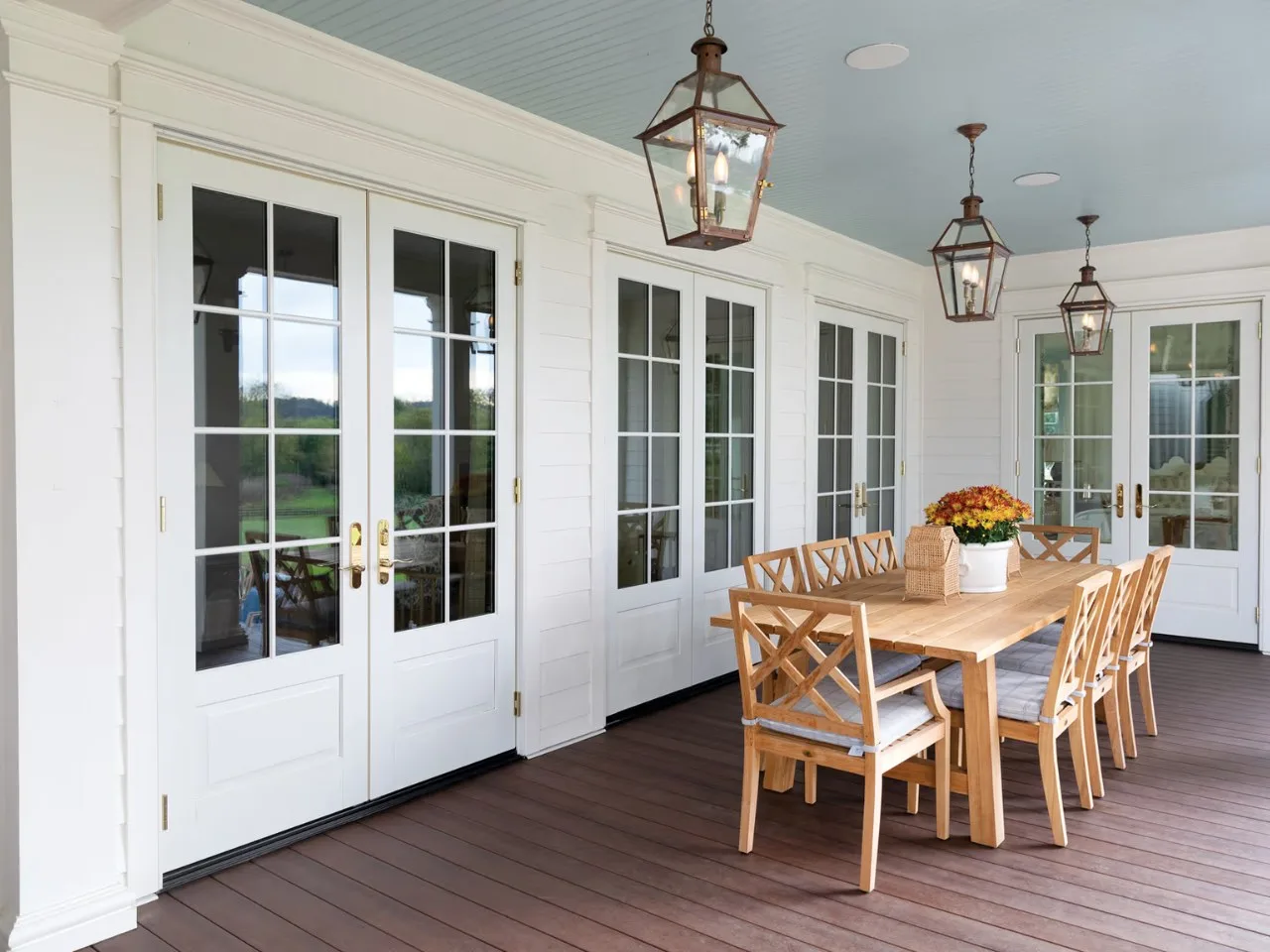 White French doors opening from a dining room onto a terrace